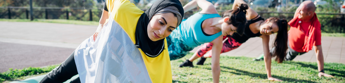 Group of participants doing yoga in open space
