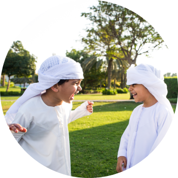 Two kids looking at each other laughing and playing, represents clear communication